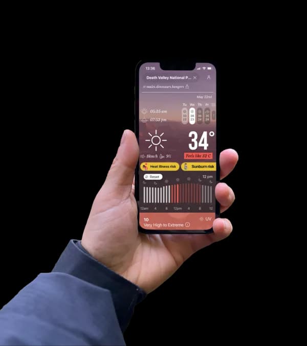 Hand holding phone with GOES app weather screen